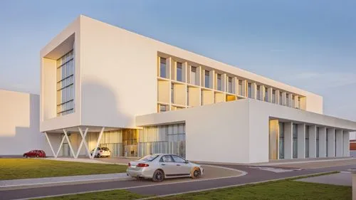 a modern hospital exterior, arch viz, people walking, cars barking, white walls, ,an unusual building with a few cars parked next to it,champalimaud,chancellery,biotechnology research institute,archit