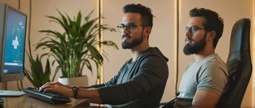 Modern digital designer, male, 30s, beard, glasses, casual wear, laptop, keyboard, mouse, coding, sitting, desk, ergonomic chair, minimalist room, bookshelf, plants, warm lighting, shallow depth of fi