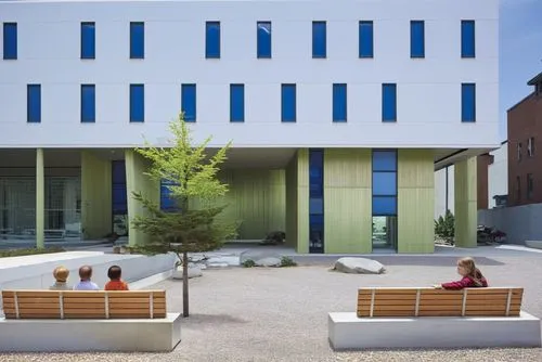 several children sit on benches in front of a building,athens art school,cohousing,passivhaus,architectes,school design,architektur,bicocca,eisenman,cubic house,biotechnology research institute,archit