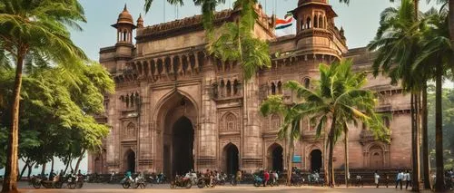 British colonial style building, India, Mumbai, old Bombay, Gateway of India, Indo-Saracenic architectural style, intricate stone carvings, ornate decorations, grand entrance, tall pillars, red brick 