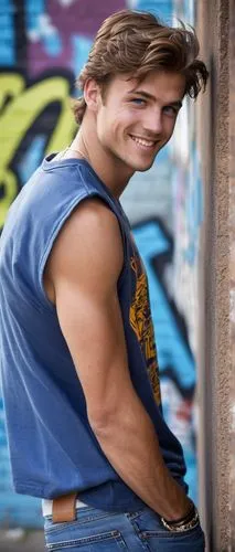 Justin Wessel, young man, athletic build, casual wear, messy brown hair, bright blue eyes, slight beard, friendly smile, leaning against a wall, one hand in pocket, relaxed posture, urban background, 