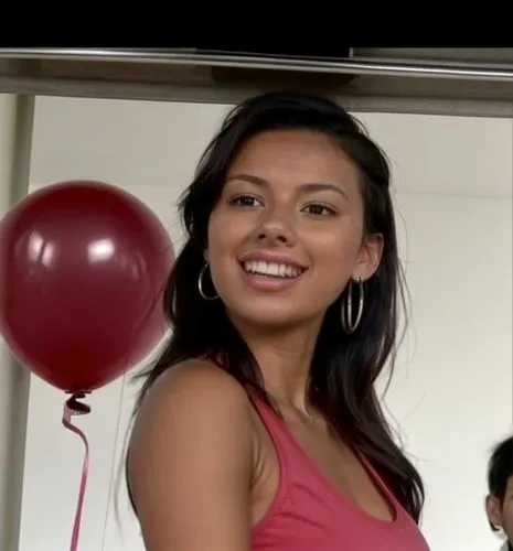 She is walking in the mall wearing short tights, a tank top and flip flops.  She looks at the balloons at the balloon stand with a smile.,mugdha,red balloons,laotian,filipino,pink balloons,guelaguetza