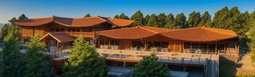 an image of a large building in the woods,smolyan,roof tile,wooden roof,roof tiles,chalet,gulmarg,thimphu,feng shui golf course,treehouses,tree house hotel,tulou,bucovina,inle,bumthang,holiday villa,e