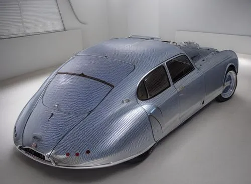 A shiny metallic silver and blue vintage Bugatti sedan in an all-white room,porsche 550,bugatti type 57s atalante number 57502,porsche 356/1,bugatti type 57,porsche 356,bugatti type 55,jaguar c-type,b