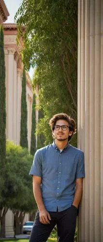 UCLA architecture graduate, young adult, male, casual wear, messy brown hair, black-rimmed glasses, facial stubble, relaxed posture, leaning against a, modern building column, University of California