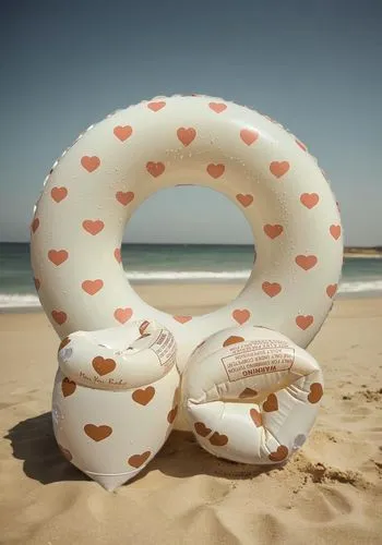 the beach under the sun,beach snake,beach furniture,lifebuoy,beach toy,inflatable ring,beach shell,inflatable,giant pretzel,life saving swimming tube,inflatable mattress,sandworm,water sofa,pebblesnai