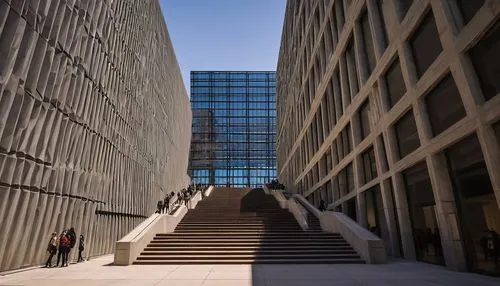 Chicago, Art Institute, modern architecture, brutalist building, angular lines, geometric shapes, glass façade, steel beams, concrete walls, grand staircase, minimalist interior, natural light pouring