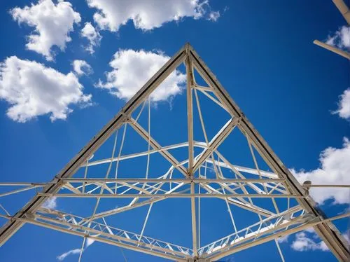 Truss, architectural element, modern building, metal framework, diagonal beams, triangular shape, sturdy structure, industrial style, urban landscape, cityscape, blue sky, fluffy white clouds, low-ang