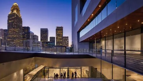 LA Architecture and Design Museum, modern building, sleek lines, large glass windows, steel frames, urban landscape, cityscape, Downtown LA, evening time, warm soft lighting, dramatic shadows, grand s