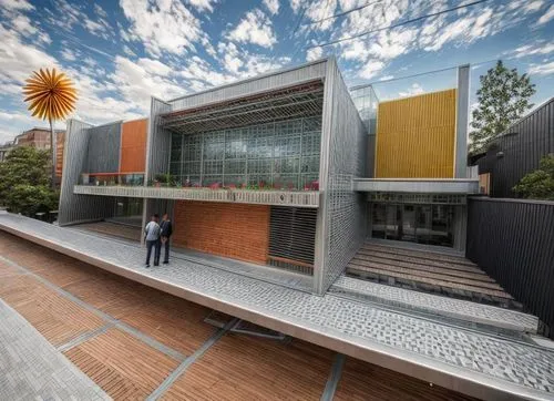 In the heart of the city, a vibrantly colored piercing smiley face greets the viewer as they approach a towering structure with a sleek metal structure. The roof is adorned with colorful flowers, and 