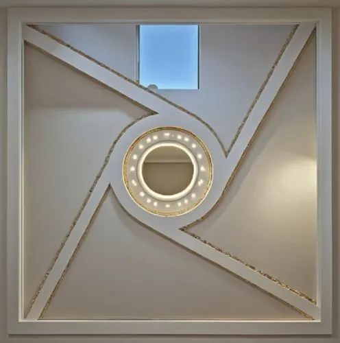 Gypsum decoration in the ceiling of a room with hidden LED lighting,the light on the ceiling is shining brightly,art deco frame,gold stucco frame,ceiling construction,stucco ceiling,circle shape frame