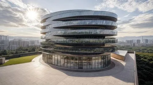 the building is made out of glass and has spirally shaped windows,singapore landmark,singapore,taikoo,escala,futuristic architecture,morphosis,the energy tower,safdie,brazilia,modern architecture,shen