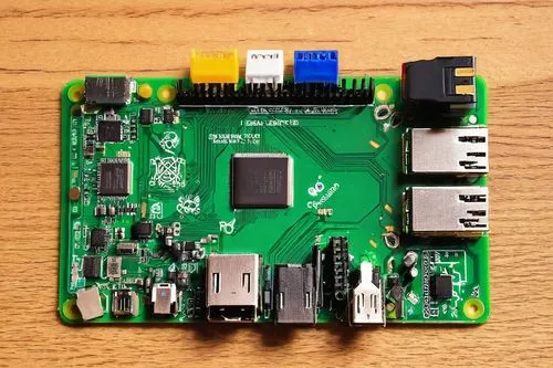 Raspberry Pi, mini computer, circuit board, microSD card slot, HDMI port, USB ports, Ethernet port, compact design, green PCB, metal casing, LED indicators, cooling fan, desktop mode, coding environme