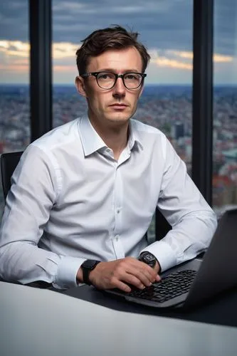 Modern architect, male, 30s, bespectacled, short brown hair, casual business attire, white shirt, dark blue jeans, sneakers, sitting, crossed legs, laptop, multiple screens, desk, ergonomic chair, mod