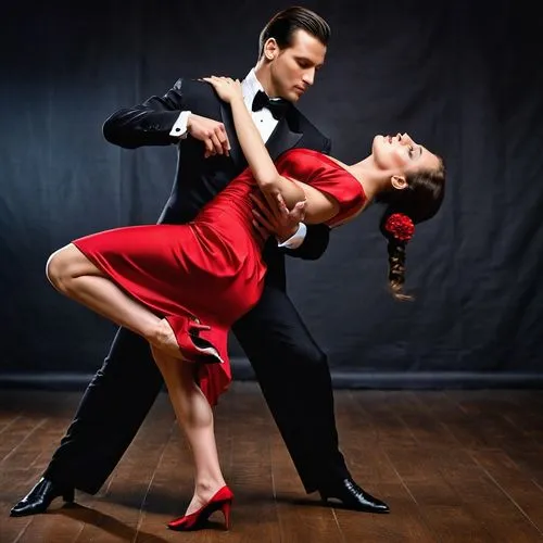 Artistas talentosos. Hermosos jóvenes, hombre y mujer, ejecutando un tango apasionado sobre un fondo negro de estudio. La seda del vestido rojo de la mujer contrasta con el traje negro del hombre, mie