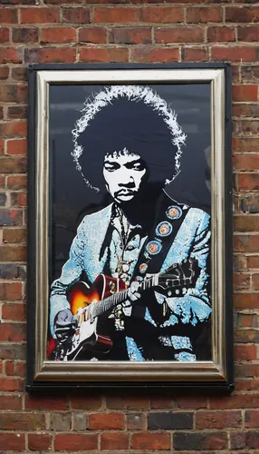 © Licensed to London News Pictures. 02/04/2013. London, UK. Staff hang a portrait of Jimi Hendrix by Manchester based mosaic artist Ed Chapman made completely from guitar plectrums in a pop-up shop se