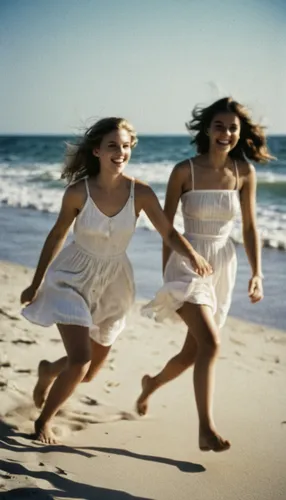 two girls run on the beach at sunset, in the style of laura makabresku, deborah turbeville, joyful chaos, frederic bazille, installation-based, candid celebrity shots, fluid movement,Looking back laug