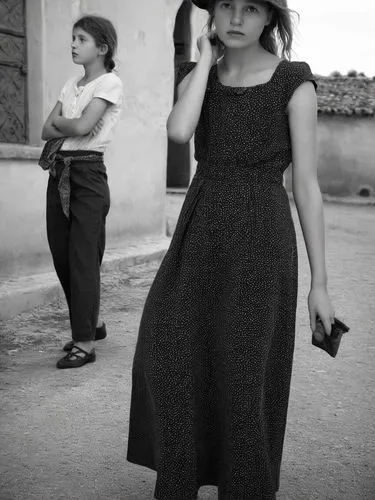 Two different women.,a woman holding an umbrella standing next to a man,cappadocians,yezidis,yazidis,girl in a long dress,yazidi,yezidi,Photography,Black and white photography,Black and White Photogra