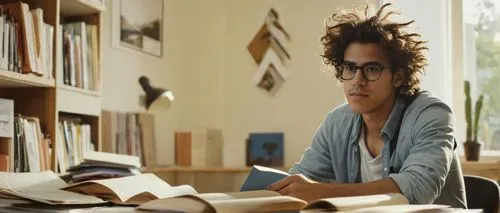 Architecture student, university setting, 20-25 years old, casual wear, glasses, messy hair, backpack, holding a large folder, sitting at a desk, surrounded by books and papers, laptop open, pencils a