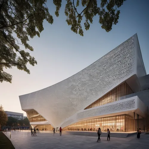 Sloped big box with curved towe public library situated within a prominent slanted structure, its façade adorned with perforated white metal sheets. In the library's immediate vicinity, you'll find a 