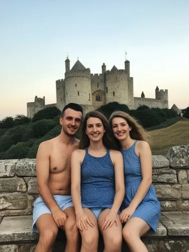 A lovely reminder of my summer vacation in England, which I spent this year with my great friends Orion Ashford and Elara Silberstern.,a young couple pose for the camera while their family sits on a b