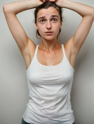 a French 30-y-o woman in white top holding her hands on her head,a woman posing with her hands on her head,girl in t-shirt,premenstrual,stressed woman,premenopausal,hypothyroidism,trichotillomania