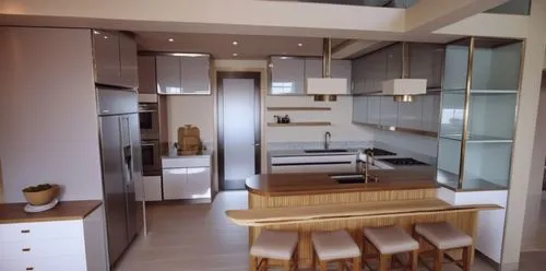 large luxurious kitchen with two color tones flush doors and drawers with profile handles. Kitchen is populated by utensils and kitchen equipment and spice jars on the shelves,this kitchen has stainle