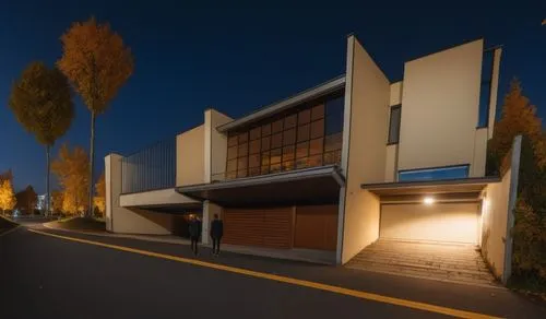 two people walk by an unusual building on a street at night,modern house,seidler,modern architecture,neutra,mid century house,midcentury,llnl,contemporary,fresnaye,townhome,residential house,metaldyne