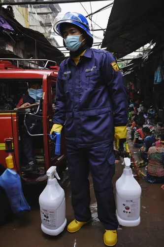 FILE - In this June 4, 2020, file photo, a fireman sprays disinfectant at mannequins as a precaution against coronavirus outbreak, at Tanah Abang textile market in Jakarta, Indonesia. As Indonesia's o