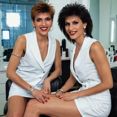 Close portrait. View of attractive rich very elegant laughing italian women with hairstyle 1980s style C C Catch,  looking straight into eyes, caressing bare upper arms, sitting in the chair and cross