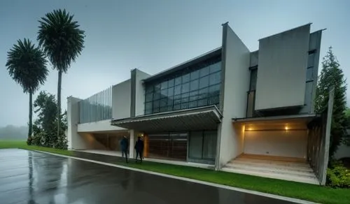 two people standing in front of an art deco home,hurricane benilde,universiti malaysia sabah,docomomo,brawijaya,ukm,wijewardene,Photography,General,Realistic