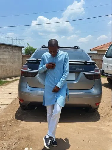 a young man in traditional garb is standing next to a vehicle,olamide,oyedeji,abaga,car loading,lavage,keyamo,Photography,General,Realistic