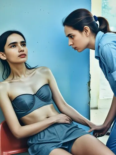 At the diaconal social welfare station.,two young women in blue dresses are sitting on red chairs,sternocleidomastoid,anorexia,dermatologist,dermatology,mastectomy,editorials