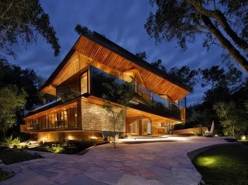 The modern two-story house sits perched on a plush orange beach, surrounded by lush green grass and palm trees. On top of the building, two distinct structures resemble the outlines of a bustling city