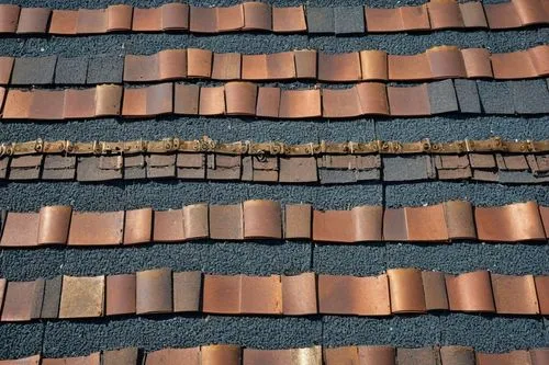 Roofing material, architectural shingle, bundle, 20-30 pieces, staggered arrangement, various colors, textured surface, asphalt or cedar material, residential building, suburban area, clear blue sky, 