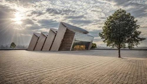 with city in the background 
keep the same color of the building
and cloudy sky ,the light shines on a building and tree in front,langemarck,sachsenhausen,holocaust memorial,christ chapel,natolin,dach