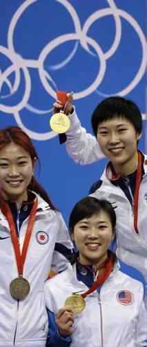 Gold medalist Virginia Thrasher of the U.S., center, poses with China's silver medal winner Du Li, left, and China's bronze medalist Yi Siling during the medal ceremony for the women's 10-meter air ri