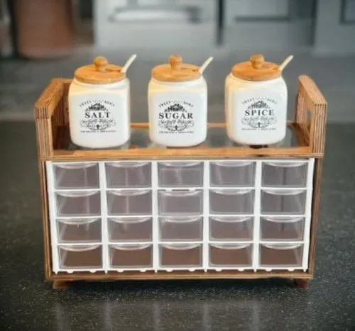 some jars that are sitting on top of some drawers,spice rack,beer sets,ice cube tray,pills dispenser,coffee soap,minibar