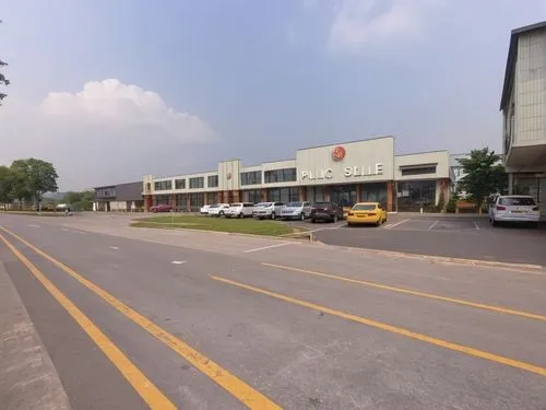 a shopping center is near an empty street without any writing,shenzhen vocational college,technopark,tampines,dunman,jengka,ukm,Photography,General,Realistic