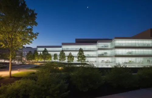 white tile, modern, multi-story, office building,  reflective glass, and silver aluminum glazing, glass with reflections,  cityscape, concrete driveways, trees, down lighting inside buildings, up ligh