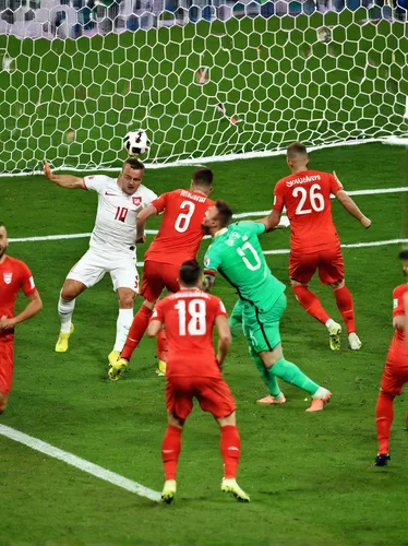 Switzerland's midfielder Xherdan Shaqiri (C-L) shoots to score hsi teams' equaliser during the Euro 2016 round of sixteen football match Switzerland vs Poland, on June 25, 2016 at the Geoffroy Guichar