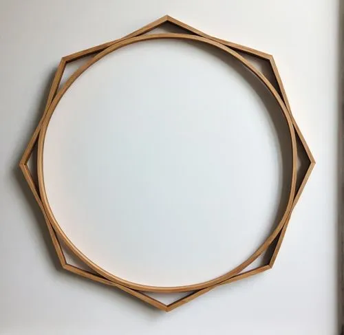 A frame made of wood against a white background,a wooden circle that is on the side of a wall,circle shape frame,wooden rings,semi circle arch,round frame,circular puzzle,oval frame,Conceptual Art,Fan