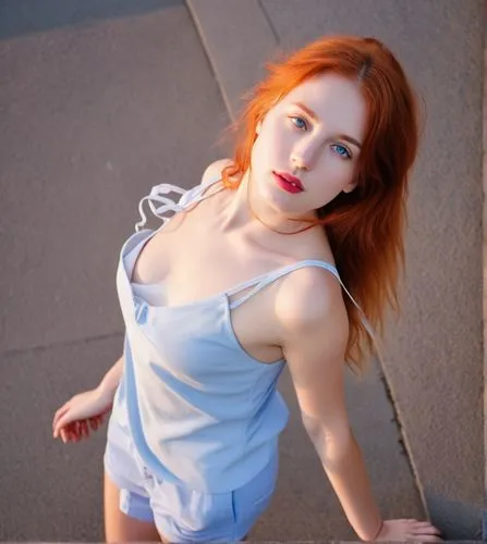 a photography of a beautiful caucasian girl 23 years old, red hair, blue eyes, red lips and glass wearing a blue top and pink shorts stand up in a street at sunset,there is a very attractive young lad