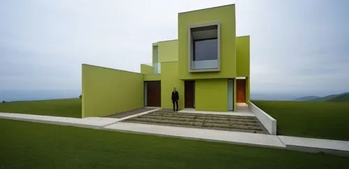 The sleek silhouette of a futuristic house is accentuated by the bold, thick hues of green contrasting against the fierce backdrop of a tall, earthy building. The streets below are dark and shrouded, 