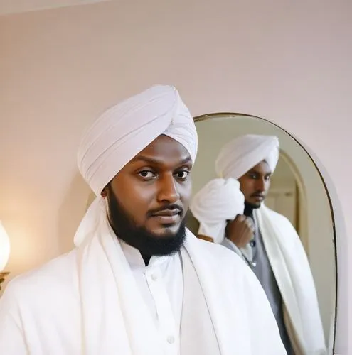 a man in a turban looks in a mirror,shaykh,abdulsalami,abubakar,ibn,alhaji,qadura