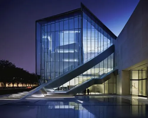 Modern museum, 2004 Smithsonian Architecture Design Award winner, sleek metallic exterior, large glass windows, angular lines, geometric shapes, urban cityscape background, night scene, soft illuminat