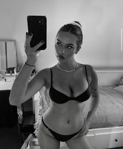 curvy girl with big tits wearing a black bikini,a woman in a bikini holding up her cellphone,taya,bw,black and white,hailie,in the mirror,sexy