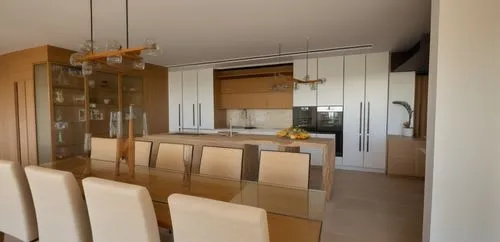 Kitchen and dining area with an island in the kitchen. Turpentine stone work surface. Kitchen cabinets from Manno Sahara. Showcase made of oak Gada. Turpentine lined. View from a residential tower in 