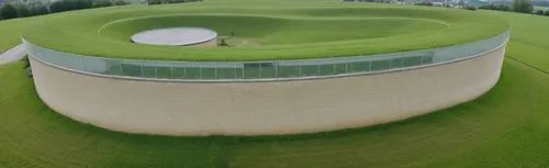 Photograph of an anthroposophical school, with large expanses of grass. Located in a village,cooling tower,storage tank,digester,digesters,sewage treatment plant,feng shui golf course,round house,gras