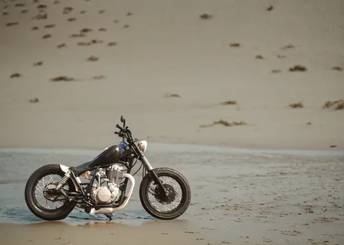 In the beach, sands, a girl rider, rocks. ,bonneville,cafe racer,panhead,girl on the dune,supermoto,harley-davidson,puch 500,harley davidson,dirt bike,triumph,sand road,high-dune,old motorcycle,cresce